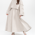 Woman wearing a antic beige dress set with a long skirt on a white background