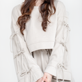 Woman wearing a antic beige dress set with a long skirt on a white background