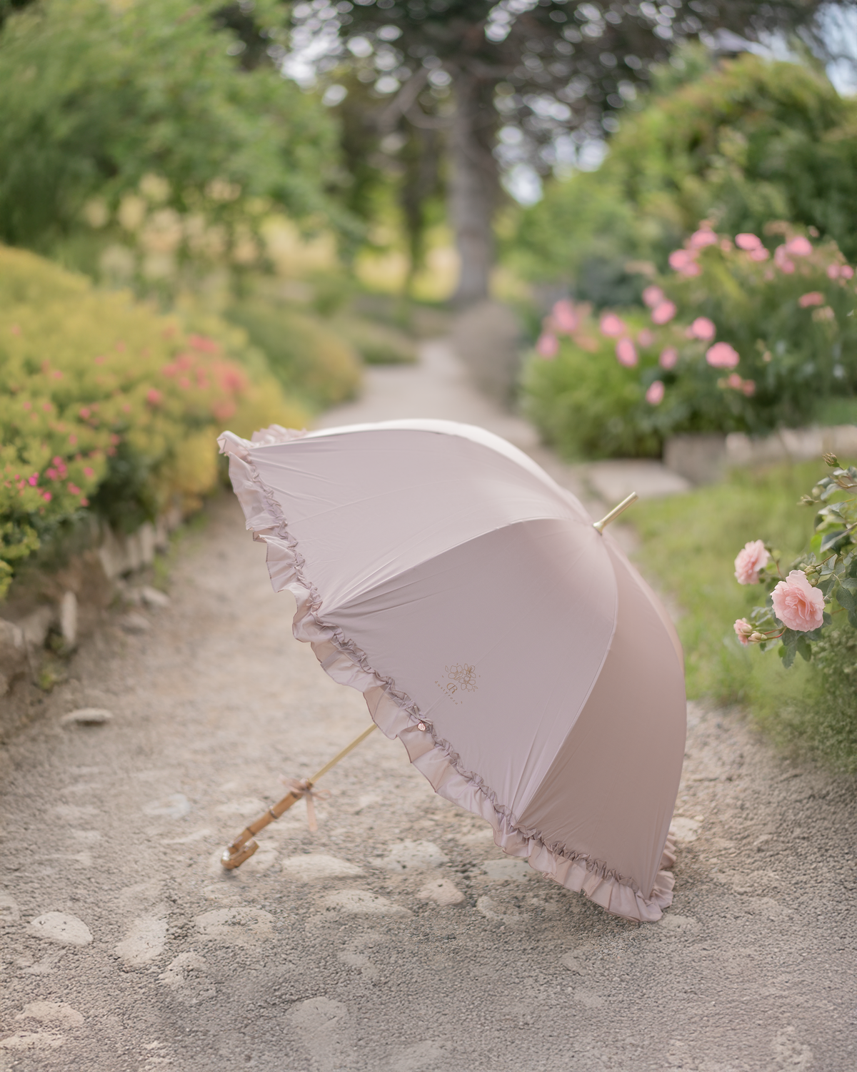 The Amaya ruffle umbrella on a garden path