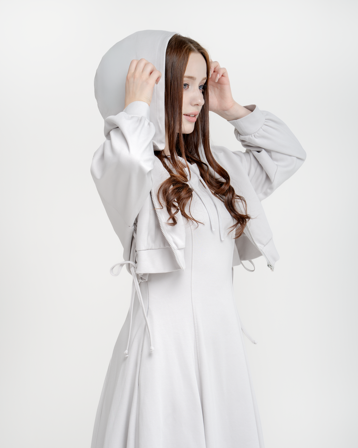 Woman wearing the lavender grey Aurora hoodie with the hood up over the matching dress