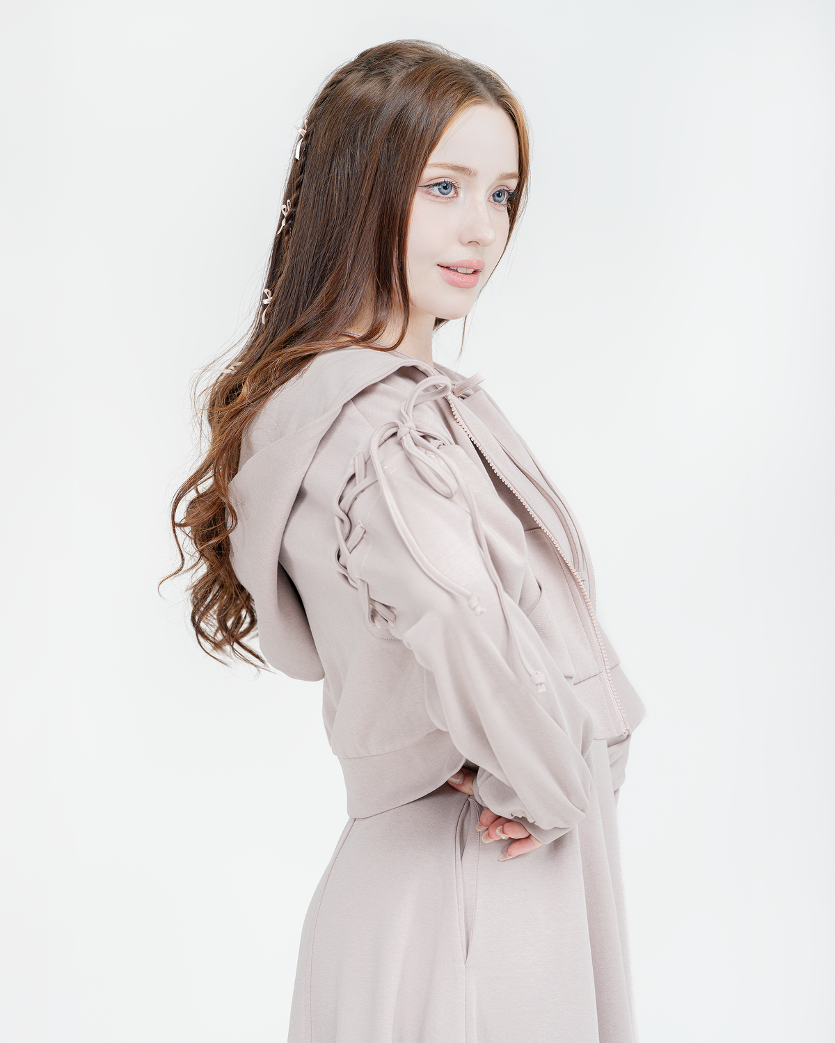 Woman wearing the dusty rose Luna tie-shoulder hoodie, close-up side view