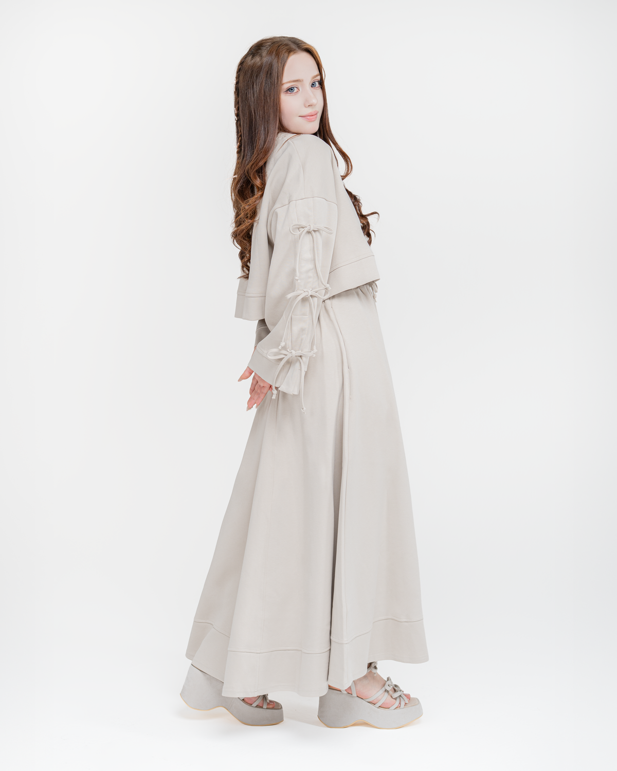 Reverie set in antique beige, side view showing the bow-tied wide sleeves