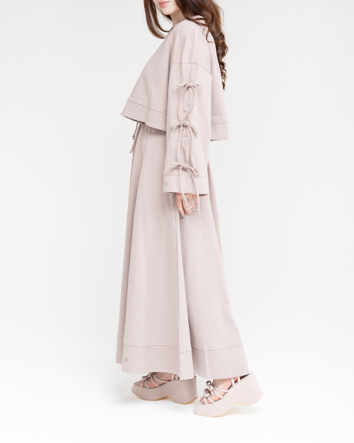 Reverie set in dusty rose, side view of the wide sleeves with cascading bows